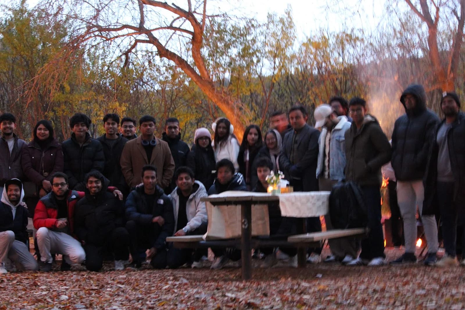 BSS community gathered outdoors among autumn trees